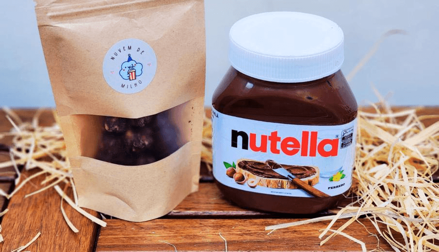 Pote de pipoca gourmet Nuvem de Nutella — Caramelo, chocolate de avelã + creme de Nutella, empanada no leite ninho.
